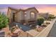 Charming single-story home with low-maintenance landscaping, walkway lighting, and a warm, inviting exterior at 9537 E Flint Dr, Gold Canyon, AZ 85118