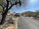 Entrance to a gated community with desert landscaping and mountain views at 9537 E Flint Dr, Gold Canyon, AZ 85118