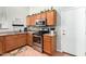 Well-equipped kitchen with wood cabinetry, stainless steel appliances, and convenient access to the garage at 9537 E Flint Dr, Gold Canyon, AZ 85118