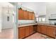 Functional kitchen with wood cabinets, granite countertops, stainless steel appliances, and tile flooring at 9537 E Flint Dr, Gold Canyon, AZ 85118