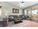 Cozy living room with comfortable seating, a ceiling fan, and a sliding glass door leading to the outdoors at 9537 E Flint Dr, Gold Canyon, AZ 85118
