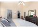 Bright main bedroom featuring a ceiling fan, walk-in closet and an ensuite bathroom at 9537 E Flint Dr, Gold Canyon, AZ 85118