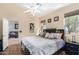 Comfortable main bedroom with wood floors, neutral walls, and a view to the living room at 9537 E Flint Dr, Gold Canyon, AZ 85118