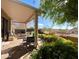 Covered patio area with a brick floor and beautiful landscaping at 9537 E Flint Dr, Gold Canyon, AZ 85118