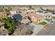 Aerial view of homes in a neighborhood, with a home featuring solar panels at 15934 W Banff Ln, Surprise, AZ 85379