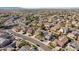 Expansive aerial view of a neighborhood with well-maintained homes and lush landscaping at 15934 W Banff Ln, Surprise, AZ 85379