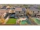 Aerial view of backyard with pool, artificial grass, and covered patio at 15934 W Banff Ln, Surprise, AZ 85379