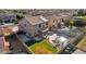 Aerial view of backyard with pool, artificial grass, and covered patio at 15934 W Banff Ln, Surprise, AZ 85379