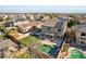 Aerial view of backyard featuring a pool, an artificial lawn, and a covered patio at 15934 W Banff Ln, Surprise, AZ 85379