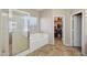 Bathroom with a shower, tub and a walk-in closet at 15934 W Banff Ln, Surprise, AZ 85379