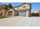 Charming home with a two-car garage, a covered carport, and a well-manicured front lawn at 15934 W Banff Ln, Surprise, AZ 85379