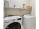 Convenient laundry room with a washer, dryer, and ample shelving at 15934 W Banff Ln, Surprise, AZ 85379