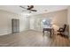 Spacious living room with wood-look floors, a ceiling fan and front door at 15934 W Banff Ln, Surprise, AZ 85379