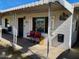 Front porch has a metal awning, the front door and a pair of cute red chairs at 1621 N 38Th Dr, Phoenix, AZ 85009