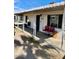 Front porch has a metal awning, the front door and a pair of cute red chairs at 1621 N 38Th Dr, Phoenix, AZ 85009