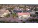 The aerial view captures the desert landscaping, private patio, and serene surroundings of the home and neighborhood at 16464 W Una Noche Ct, Surprise, AZ 85374