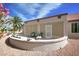 Charming backyard with a curved patio, comfortable seating, desert landscaping, and a serene ambiance at 16464 W Una Noche Ct, Surprise, AZ 85374