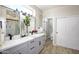 Bright bathroom showcasing gray vanity with double sinks and full shower and tub combo at 16464 W Una Noche Ct, Surprise, AZ 85374