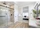 Modern bathroom featuring a glass enclosed shower and stylish vanity with double sinks at 16464 W Una Noche Ct, Surprise, AZ 85374