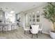 Bright dining area adjacent to the kitchen with a glass table and upholstered chairs at 16464 W Una Noche Ct, Surprise, AZ 85374