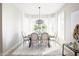 Elegant dining room with modern chandelier and white draperies and shutters, perfect for entertaining guests at 16464 W Una Noche Ct, Surprise, AZ 85374