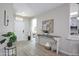 Bright and airy entryway featuring tile floors, a console table, and access to the living spaces at 16464 W Una Noche Ct, Surprise, AZ 85374