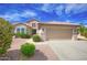 Inviting single-Gathering home featuring a tile roof, a two-car garage, and beautiful desert landscaping at 16464 W Una Noche Ct, Surprise, AZ 85374