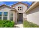 Welcoming front entry with a decorative window, covered porch, and desert landscaping at 16464 W Una Noche Ct, Surprise, AZ 85374