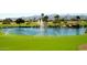 Picturesque golf course with a scenic pond and fountain views at 16464 W Una Noche Ct, Surprise, AZ 85374