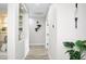 Hallway with gray walls, tile flooring, and decorative accents at 16464 W Una Noche Ct, Surprise, AZ 85374