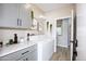 Functional laundry room with gray cabinets, modern appliances, ample counter space, and stylish decor at 16464 W Una Noche Ct, Surprise, AZ 85374