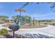 Community playground with slides and play equipment sitting on a bed of mulch under a sunshade at 17166 W Oberlin Way, Surprise, AZ 85387