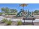 Community playground featuring slides, climbing structures and a shaded bench area at 17166 W Oberlin Way, Surprise, AZ 85387