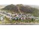 An aerial view of the homes on a cul-de-sac and their proximity to the mountains in the distance at 1723 E Behrend Dr, Phoenix, AZ 85024