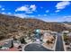 An aerial view shows the home in its neighborhood near scenic hills at 1723 E Behrend Dr, Phoenix, AZ 85024