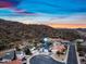 An aerial view shows the home in its neighborhood near scenic hills at 1723 E Behrend Dr, Phoenix, AZ 85024