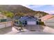 Aerial view of a single-Gathering home nestled in a neighborhood near rolling desert mountains at 1723 E Behrend Dr, Phoenix, AZ 85024