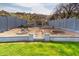 Landscaped backyard featuring tiered hardscape, stone accents and retaining wall for privacy at 1723 E Behrend Dr, Phoenix, AZ 85024