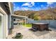 Paver patio with a hot tub and a covered outdoor seating area, set against a scenic hillside backdrop at 1723 E Behrend Dr, Phoenix, AZ 85024