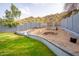 Spacious backyard featuring manicured grass and a partially landscaped hillside for added privacy at 1723 E Behrend Dr, Phoenix, AZ 85024