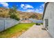 Lush backyard featuring a stone patio, well-maintained lawn, and natural desert surroundings with mountain views at 1723 E Behrend Dr, Phoenix, AZ 85024