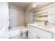 Bright bathroom showcasing tile, a bathtub, and a sleek vanity at 1723 E Behrend Dr, Phoenix, AZ 85024