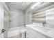 Stylish bathroom featuring a tub-shower combo, a large mirror, and a vanity with a white countertop and cabinets at 1723 E Behrend Dr, Phoenix, AZ 85024