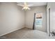 Cozy bedroom featuring carpeted floors, a ceiling fan, and natural light through a window overlooking the backyard at 1723 E Behrend Dr, Phoenix, AZ 85024