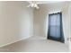 Neutral carpeted bedroom with a ceiling fan and light-blocking curtain at 1723 E Behrend Dr, Phoenix, AZ 85024