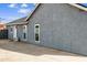 Side view of the exterior with gray stucco and a concrete slab at 1723 E Behrend Dr, Phoenix, AZ 85024