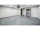 Spacious garage featuring finished epoxy floors, multiple doors, and fixtures, perfect for a workshop or storage at 1723 E Behrend Dr, Phoenix, AZ 85024