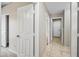 Neutral hallway featuring access to rooms through white doors and featuring tile flooring, enhancing the home's contemporary feel at 1723 E Behrend Dr, Phoenix, AZ 85024