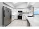 Modern kitchen featuring white cabinets, stainless steel appliances, tile backsplash, and a skylight for natural light at 1723 E Behrend Dr, Phoenix, AZ 85024