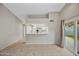 Open living room with tile floors and view of the kitchen at 1723 E Behrend Dr, Phoenix, AZ 85024